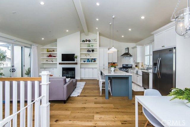 The subtle contrast of flooring, cabinet color and stainless steel appliance makes for a scene our of pottery barn.