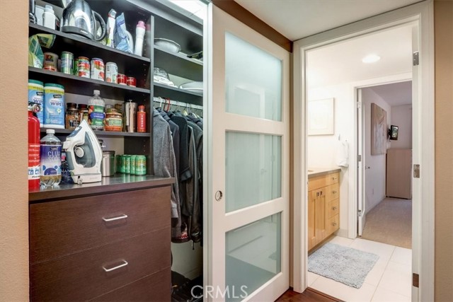 Hallway double frosted doors closet with room for a pantry, extra storage and hanging space!