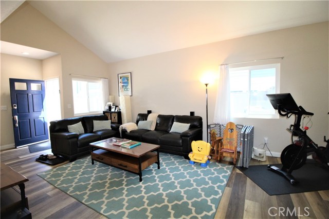 Spacious bright and sunny living room with fireplace and vaulted ceilings