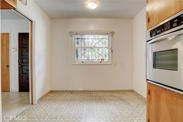 This view shows the kitchenette eating space in the kitchen. It is a great space for a small table for quick or informal meals. To the left is the door to the dining room, and to the right is the door to the laundry room and the garage beyond.