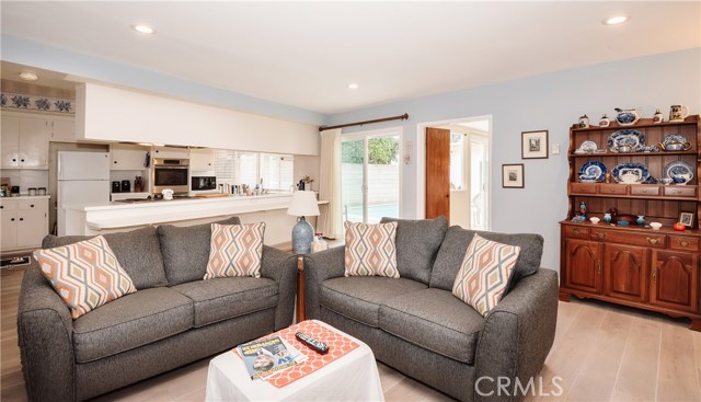 living room with view of kitchen and pool