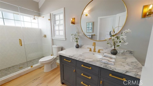 Here is the dual purpose guest bathroom/powder room, office bathroom. the large shower has so much natural light, wood pitched ceiling gives the room a very large sense of space