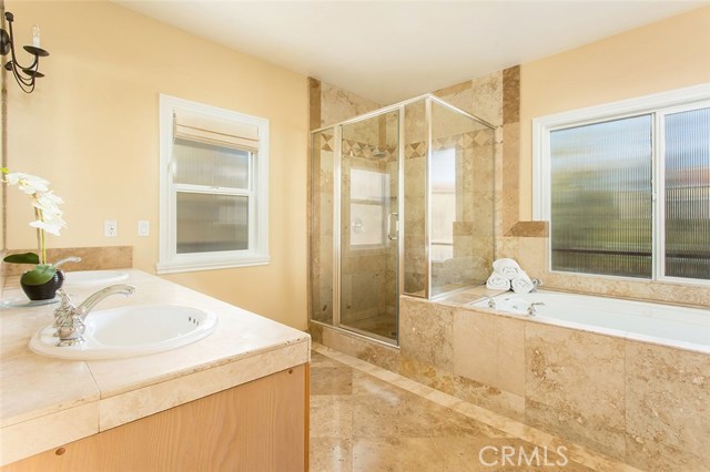 Dual vanities, large stand up shower enclosure, and over-sized jetted tub.
