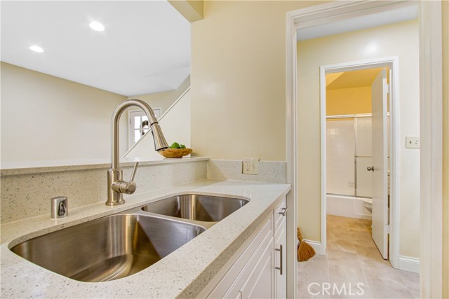 New sink, faucets , custom cabinetry , quartz counters, recessed lighting and new flooring.