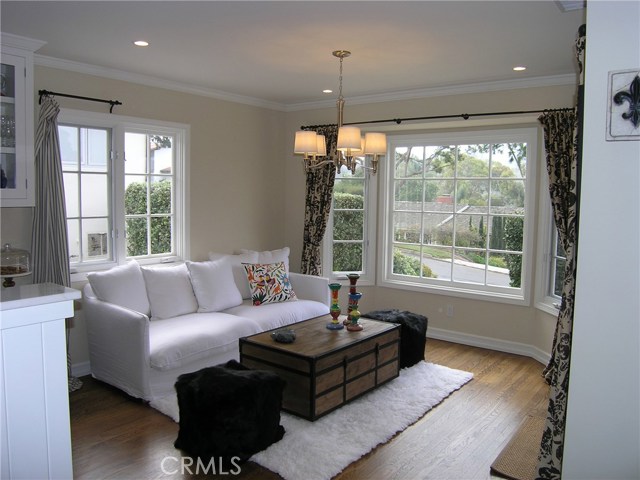 A cozy family room with French doors to the front patio and a lovely view of the hills.