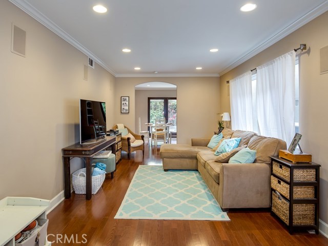 Living room has beautiful wood floors, recessed lighting, and surround sound.