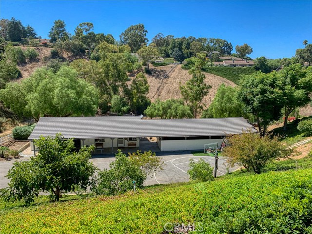 The barn/guesthouse/rumpus room complex sits on a lower plateau.The two car attached garages here are currently set up as a workout space. There is also a full half court basketball area.