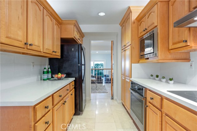 A second pantry (with roll-out shelves) can be seen on the right.  Door leads to dining room, open to living area and views.