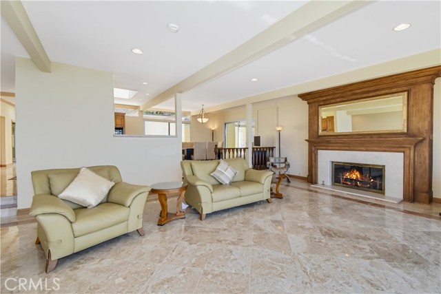 Another perspective on the spacious living room with a peak of the dining room which also has a great view.