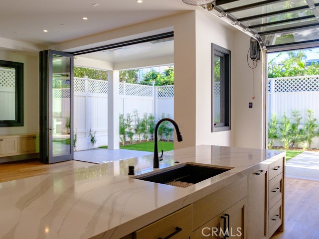 The clean, open look from the Kitchen, across the Great Room to the Patio.