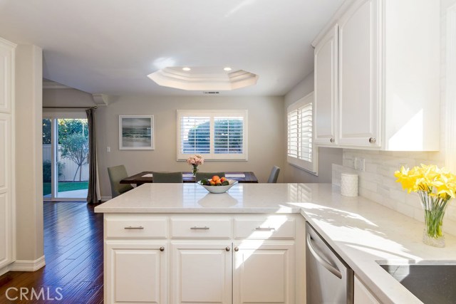 Quartz countertops and marble tile backsplash