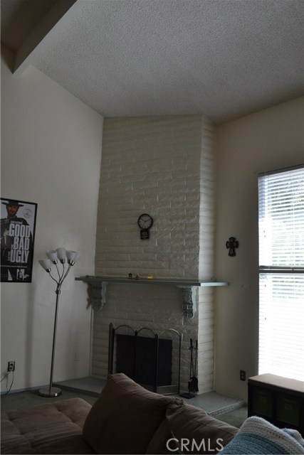 Fireplace in northeast corner of living area, same wall as entryway.