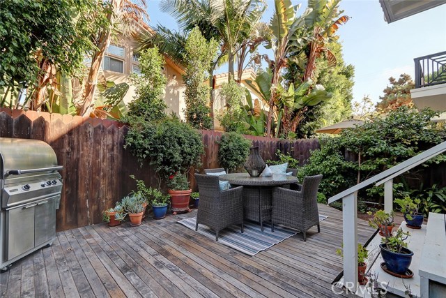 Private backyard with large wooden deck great for outdoor entertaining.