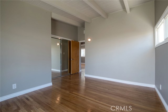BACK BEDROOM SHOWING HIGH BEAMED CEILINGS, TRIMLINE MIRRORED CLOSET DOORS