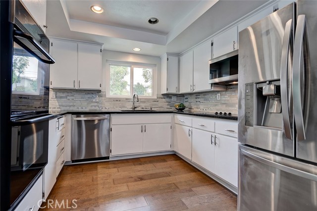 Full kitchen features, granite countertops, double ovens, microwave, dishwasher, cooktop and large refrigerator.