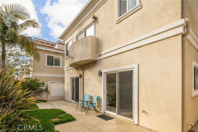 The grassy backyard is a great outdoor space for play, recreation, and relaxation.