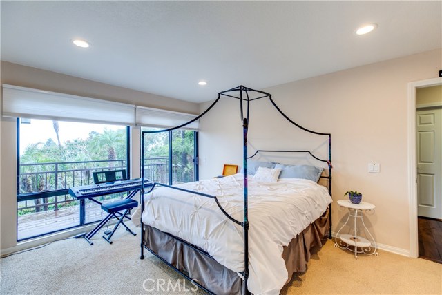 This 3rd bedroom features carpet and a balcony