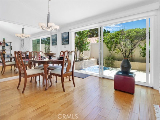 Inviting dining area opens to private patio with multiple fruit trees.