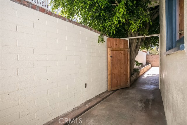 Adjoining the rear patio is a storage area that also circles around the side of the home