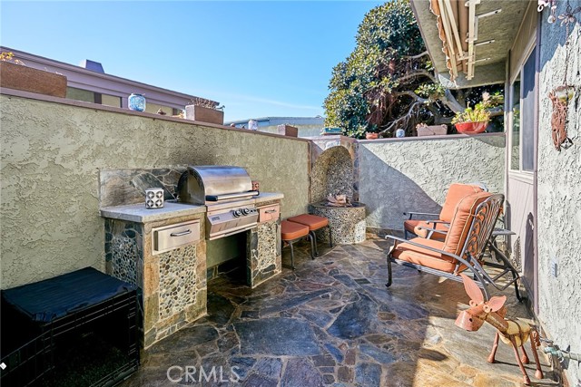 This one of a kind Venetian front porch was designed and crafted by a European craftsman. Each Kashmir stone was individually cut and placed to form a mosaic. The porch features a BBQ station with a built in, gas Fire Magic grill coupled with a cozy built in corner gas fire pit to keep you warm during the cooler months or breezy beach city nights.