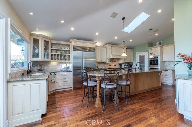 Huge kitchen with island seating for up to 10 has all newer stainless appliances, double oven, walk-in pantry, and outrageous views to make your day!