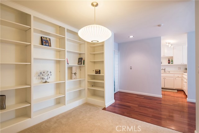 Built-in bookshelves in the den and beautiful wood floors in the entry & kitchen.