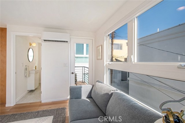 3rd level living room with powder room and door to back grilling patio. (Facing East)