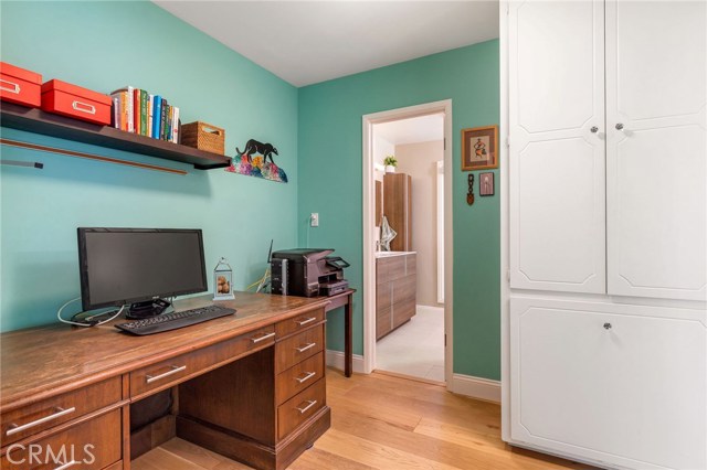 Desk/computer area in main bedroom entry, linen storage and totally remodeled bathroom.