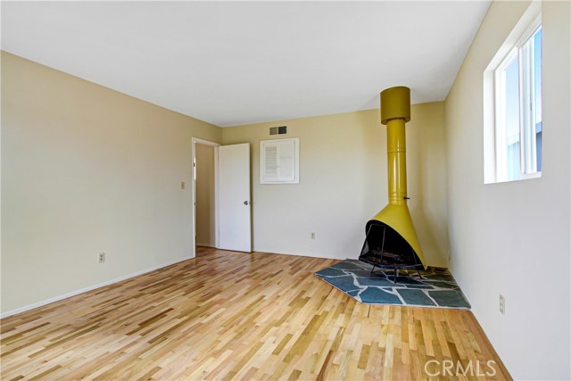 Largest bedroom with refinished original hardwood flooring, walk in closets , new dual paned windows. Vintage wood burning fire place & stone Tile work.