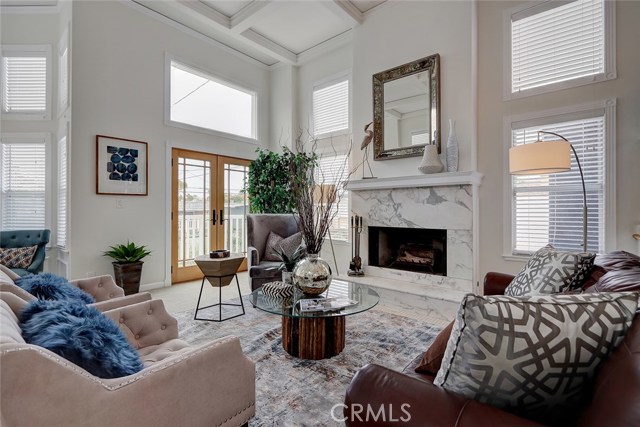The fireplace is the focal point of the living room with marble stone around the entry and on the hearth.