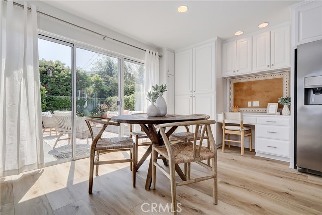 MAIN FLOOR BREAKFAST NOOK AREA, KITCHEN DESK, AND ADJACENT SLIDING GLASS DOORS TO PRIVATE BACKYARD PATIO AREA
