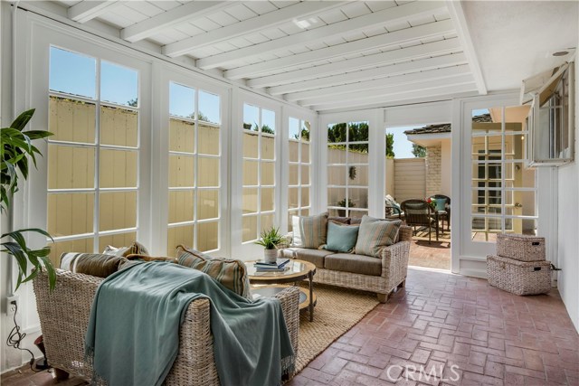 Enclosed sun room opens to outside patio, office and laundry room