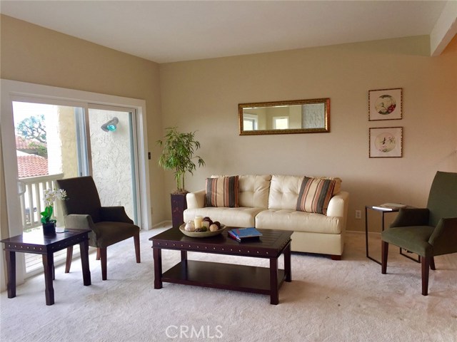 Large living room with fireplace & wrap around balcony & views. Large living room with fireplace & wrap around balcony & views.