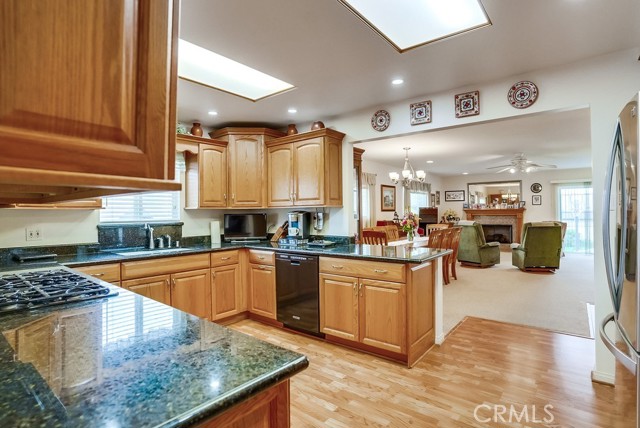 Kitchen opens to dining area, family room w fireplace and yard