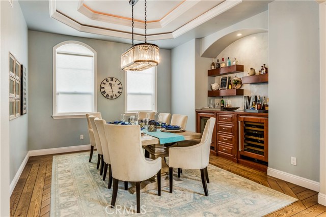 Rare Formal Dining Room in a townhome in South Redondo with a custom bar with sub-zero beverage cooler & wine cooler.   Restoration Hardware crystal chandelier also added by current owner