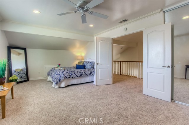 The double doors at the top of the stairs lead to the oversized master bedroom with recessed lights, ceiling fan and new carpet.