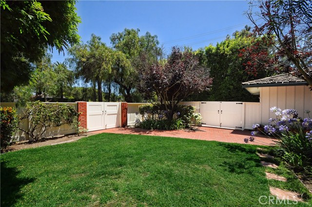 As you enter the front gate, you're welcomed with this greenery and landscaped exterior.