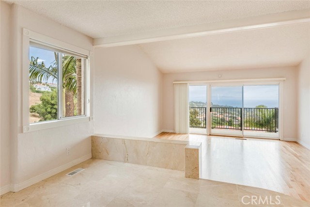 Oversized master suite features sweeping ocean and Catalina views, sitting area, vanity area, and walk-in closet.