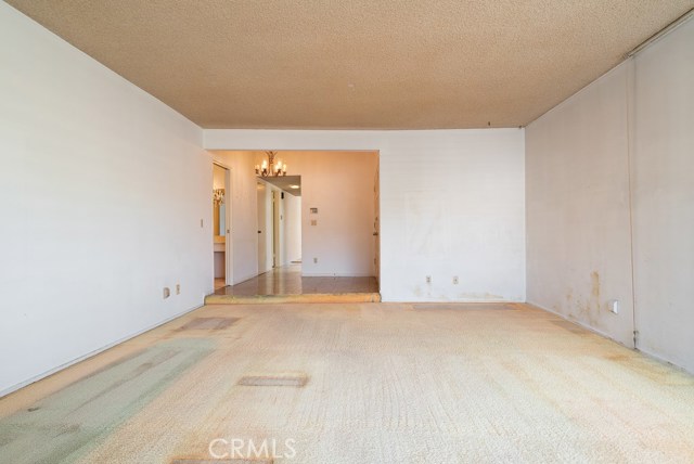 Large, front facing living room. This picture is obviously looking back towards the entrance (behind wall on right).
As you can see the interior needs a total make over.