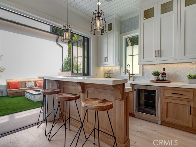 Neolith stone counters, Thermador professional series appliances, dual sinks, additional beverage fridge, Brizo faucets, breakfast counter, indoor/outdoor bar & entertainment area that opens to backyard.