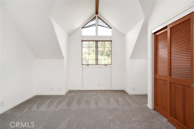 One of two front facing (north facing) bedrooms with dormer windows, vaulted ceilings and large closets. All new carpeting upstairs and on staircase.