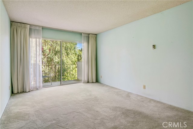 master bedroom with sliding glass doors that open to a baclony.