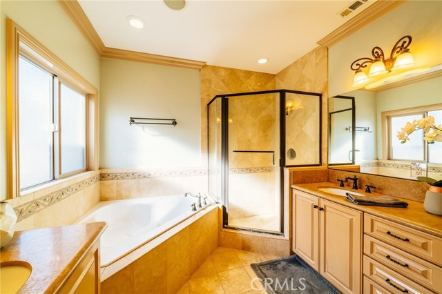 A luxurious master bath with dual vanities, jetted tub, and a large walk-in closet is a peaceful retreat. In addition to the vanity's cabinetry you will find linen cabinetry in the master bath.