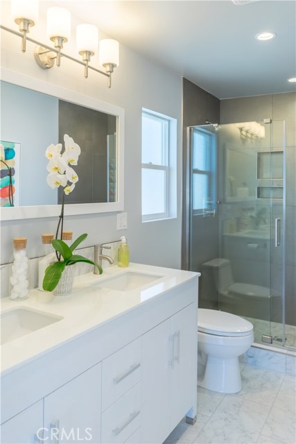 Designer tile and seamless shower doors are featured in the Master bath.