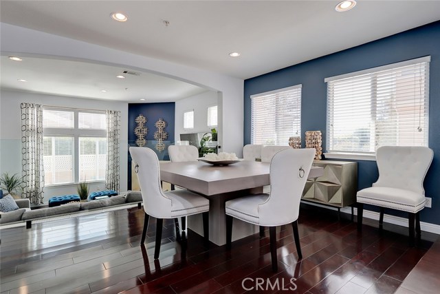 Formal dining area with arched ceiling detail overlooking the entry level great room.