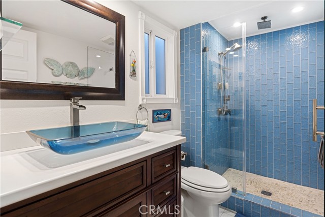 The gorgeous spa-like primary bathroom with custom tile and cabinetry.