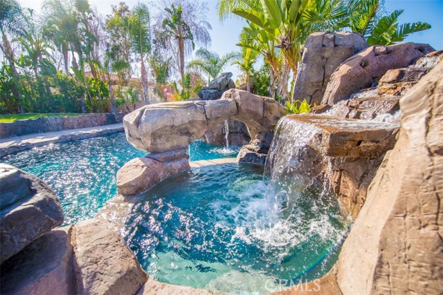 Spa with Waterfall and a View to the Pool.