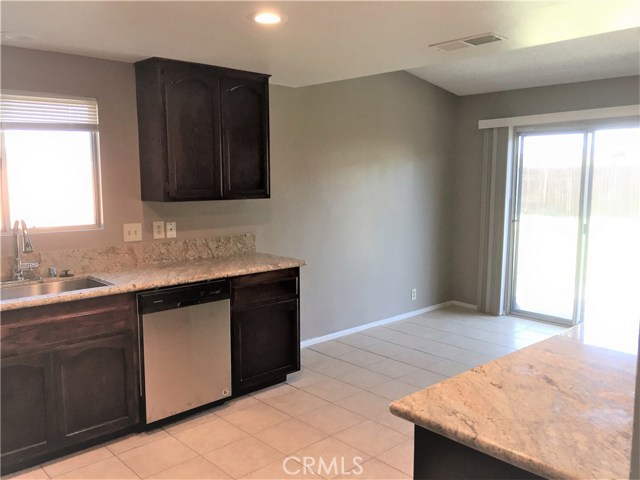 The dining area adjoins the kitchen and offers access to the patio beyond.