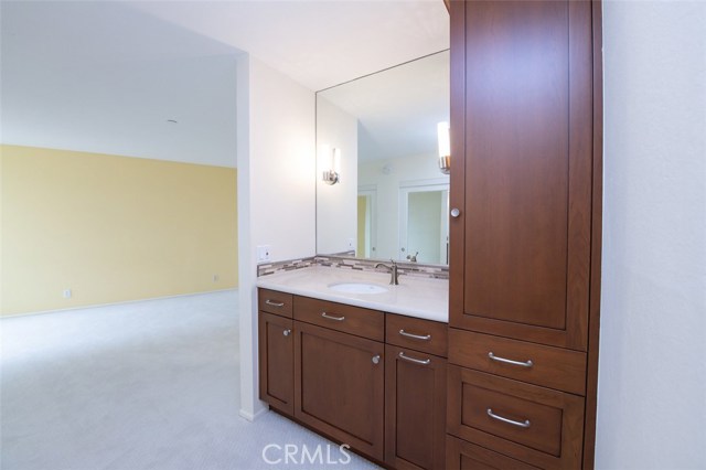 Vanity Counter Caesarstone with BrookHaven Frameless Cherry Wood Cabinetry