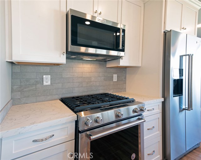 KITCHEN-AID SELF CLEANING/CONVECTION GAS STOVE,  MICROWAVE, QUARTZ COUNTERS AND FINE ITALIAN PORCELAIN TILE